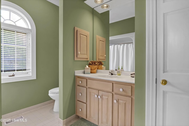 bathroom featuring vanity, tile patterned floors, and toilet