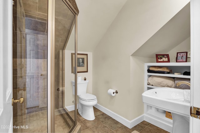 bathroom with vaulted ceiling, tile patterned floors, toilet, and walk in shower