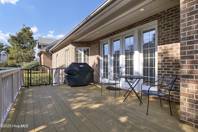 deck with french doors and a grill