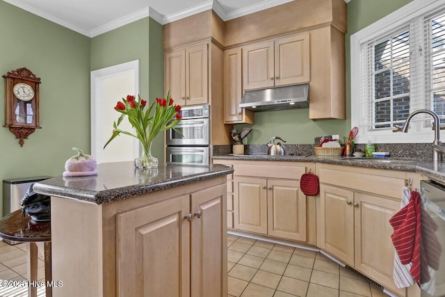 kitchen with sink, crown molding, appliances with stainless steel finishes, a kitchen island, and light brown cabinetry