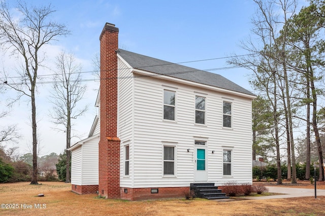 colonial-style house with a front lawn