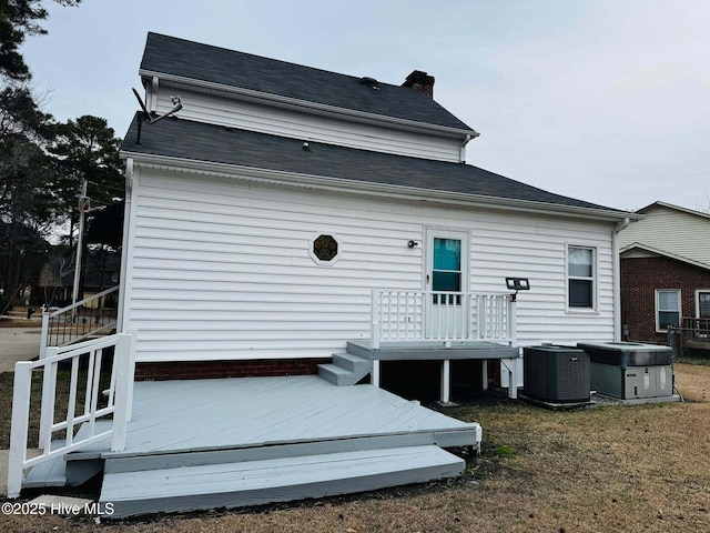 rear view of house featuring a deck and central air condition unit