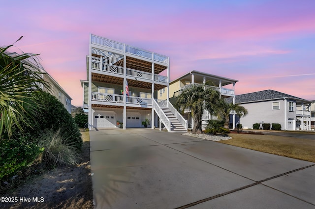 raised beach house with a garage and a balcony