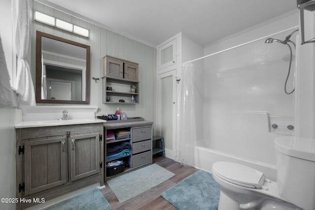 full bathroom featuring shower / bath combination with curtain, hardwood / wood-style flooring, vanity, ornamental molding, and toilet