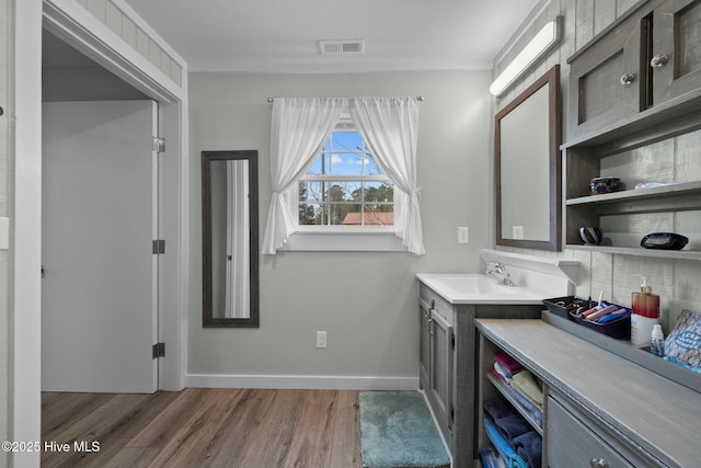 interior space with vanity and hardwood / wood-style flooring