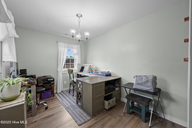 office space with wood-type flooring and a chandelier