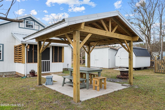 view of patio / terrace with a sunroom and a storage unit