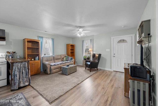 living room with ceiling fan and light hardwood / wood-style floors