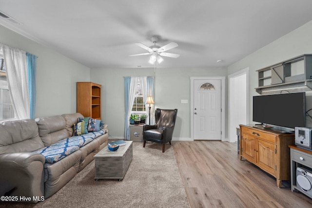 living room featuring ceiling fan and light hardwood / wood-style floors