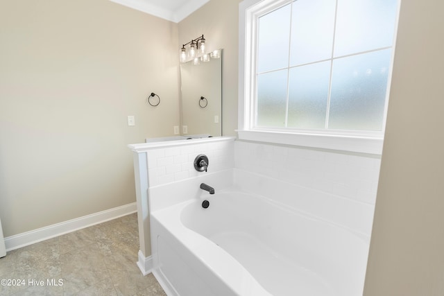 bathroom with a tub to relax in and crown molding