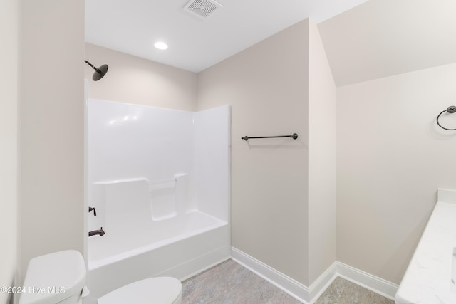 bathroom with tub / shower combination and toilet