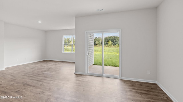 unfurnished room with hardwood / wood-style floors