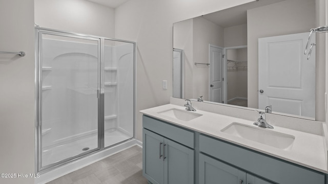 bathroom with vanity and a shower with shower door