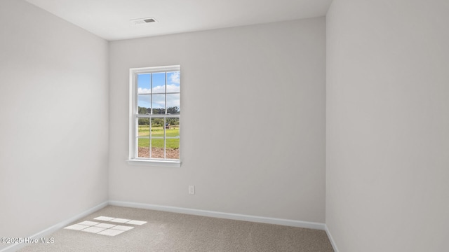 carpeted spare room featuring plenty of natural light