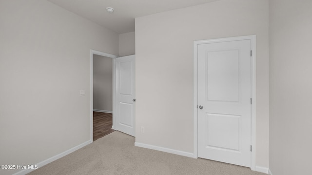 unfurnished bedroom featuring light carpet