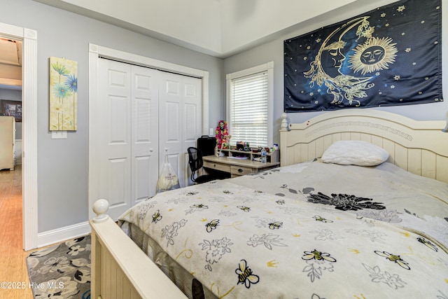 bedroom featuring hardwood / wood-style floors and a closet