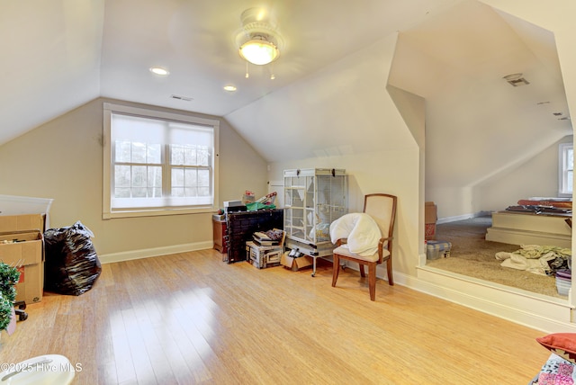 sitting room with vaulted ceiling and light hardwood / wood-style floors