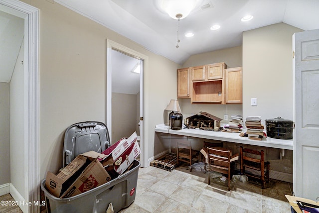 kitchen featuring lofted ceiling and light brown cabinetry