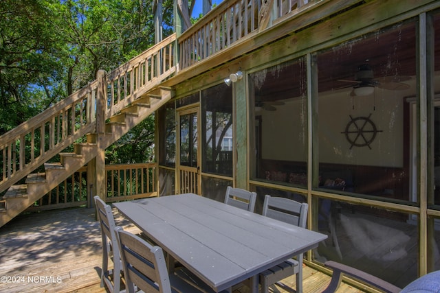 1981 New River Inlet Rd, North Topsail Beach, NC 28460 - wooden terrace with stairway, ceiling fan, a sunroom, and outdoor dining area