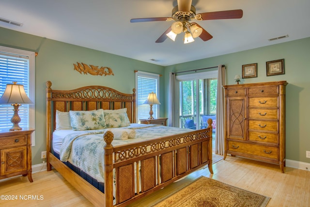 1981 New River Inlet Rd, North Topsail Beach, NC 28460 - bedroom with light wood finished floors, multiple windows, and ceiling fan