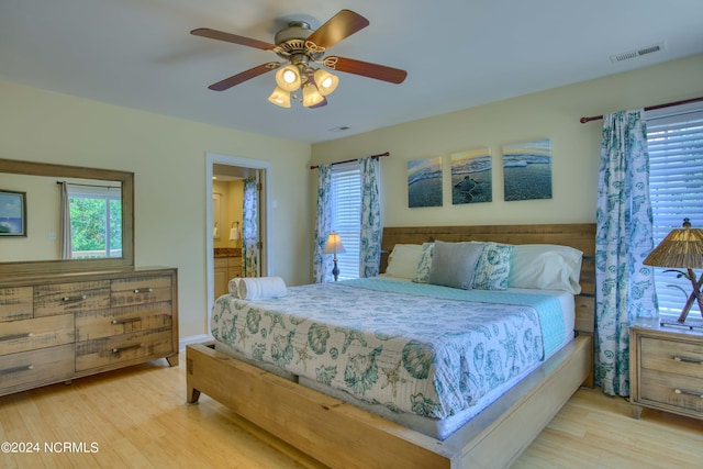1981 New River Inlet Rd, North Topsail Beach, NC 28460 - bedroom with wood finished floors, ensuite bath, and a ceiling fan
