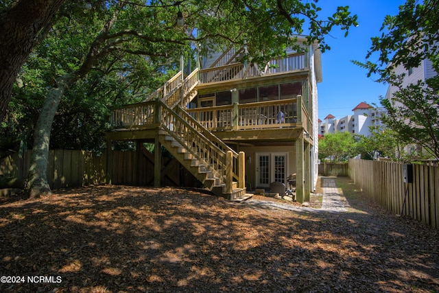 1981 New River Inlet Rd, North Topsail Beach, NC 28460 - rear view of house with stairway, a fenced backyard, a wooden deck, and french doors