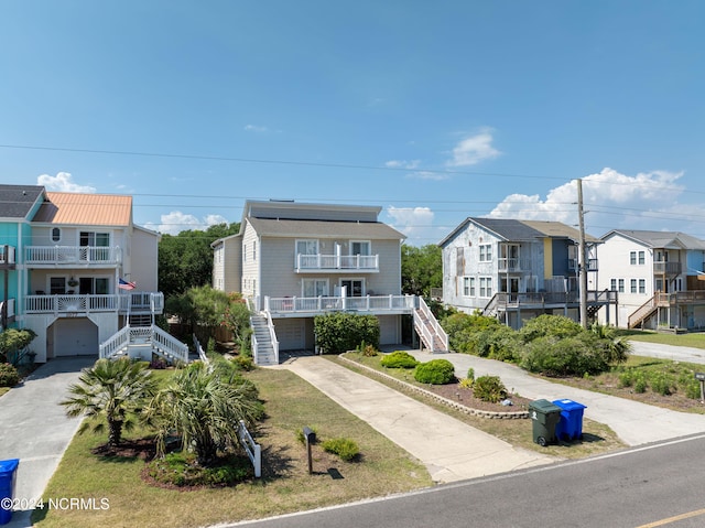 1981 New River Inlet Rd, North Topsail Beach, NC 28460 - coastal home featuring stairway, a garage, concrete driveway, and a residential view