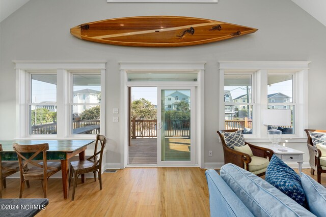 doorway featuring lofted ceiling and light hardwood / wood-style floors