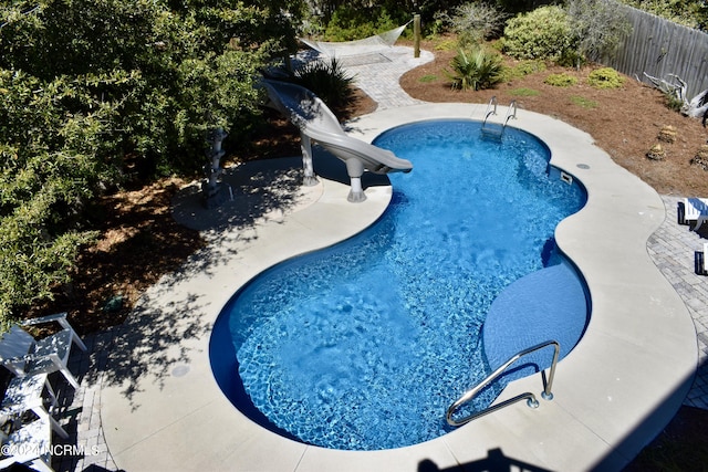 view of pool with a patio and a water slide