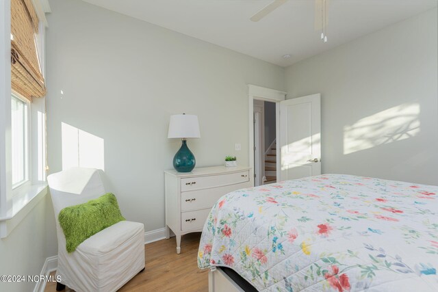 bedroom with ceiling fan and light wood-type flooring