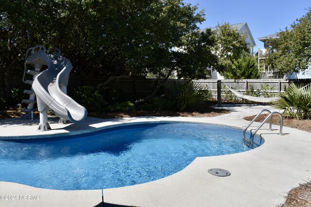 view of pool featuring a water slide