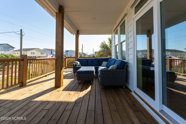 wooden deck with an outdoor living space