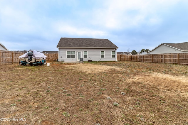 rear view of house with a yard