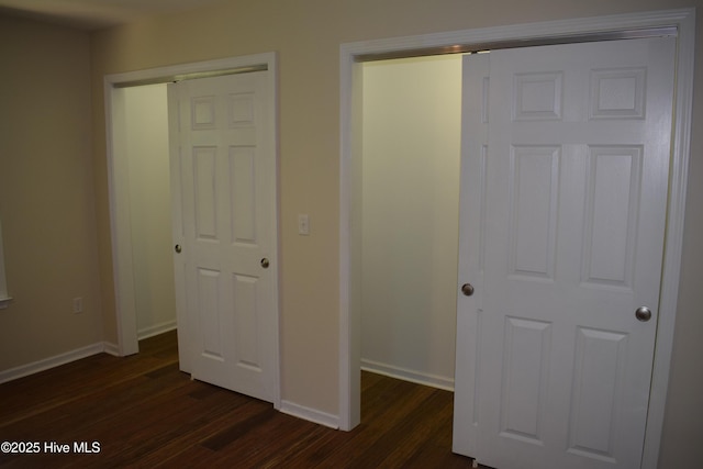 7304 E Oak Island Dr, Oak Island, NC 28465 - unfurnished bedroom with dark wood finished floors and baseboards