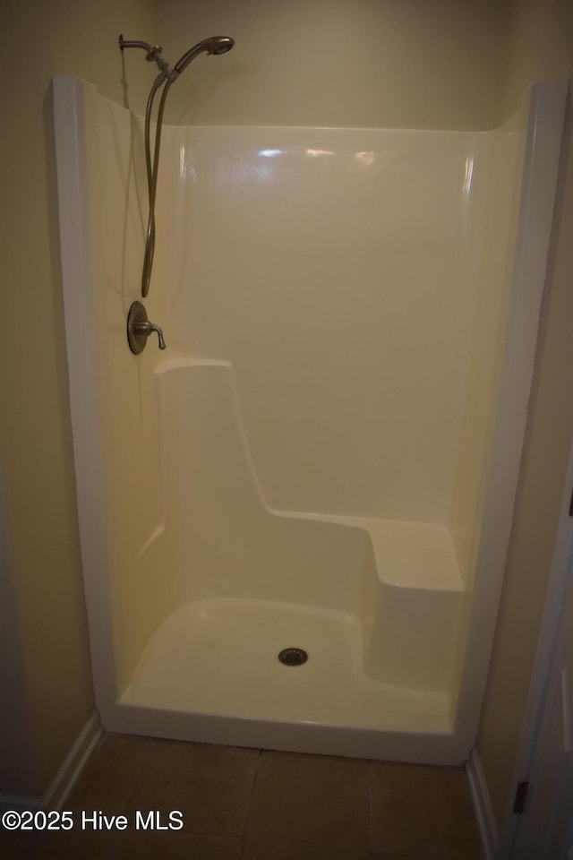 7304 E Oak Island Dr, Oak Island, NC 28465 - full bathroom with a shower, tile patterned floors, and baseboards