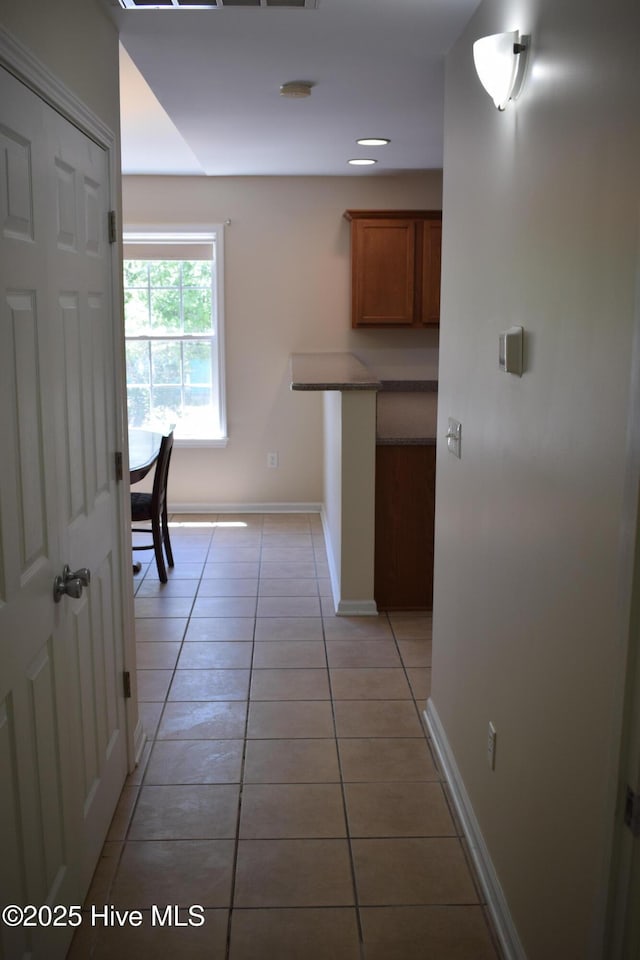 7304 E Oak Island Dr, Oak Island, NC 28465 - corridor featuring light tile patterned floors and baseboards