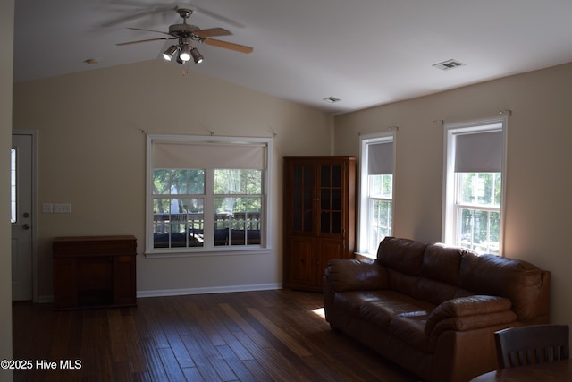 7304 E Oak Island Dr, Oak Island, NC 28465 - living room featuring hardwood / wood-style flooring, healthy amount of natural light, a ceiling fan, lofted ceiling, and baseboards