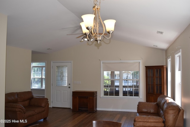 7304 E Oak Island Dr, Oak Island, NC 28465 - living area with lofted ceiling, wood finished floors, a chandelier, and baseboards