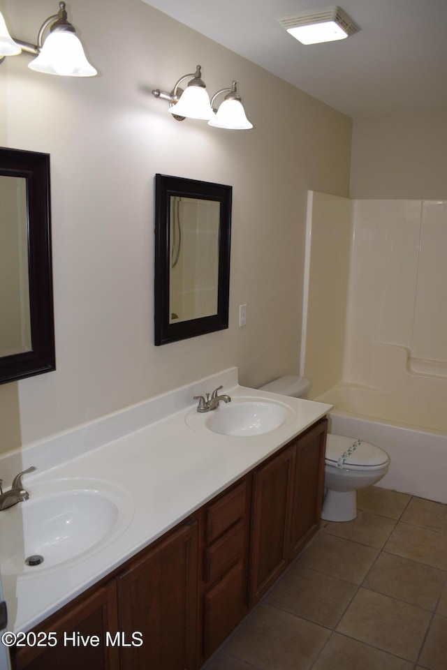7304 E Oak Island Dr, Oak Island, NC 28465 - bathroom featuring toilet, double vanity, tile patterned flooring, and bathtub / shower combination