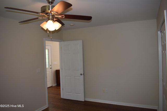 7304 E Oak Island Dr, Oak Island, NC 28465 - spare room featuring ceiling fan, dark wood finished floors, and baseboards