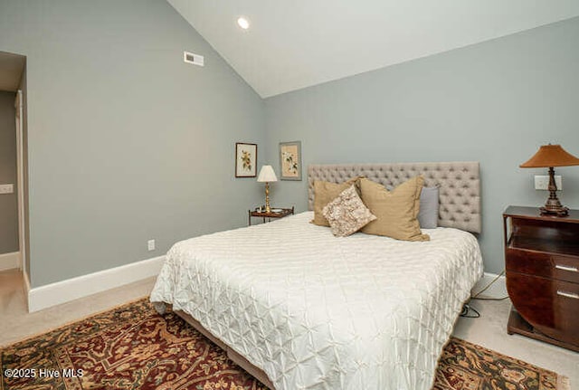 bedroom featuring high vaulted ceiling and light colored carpet