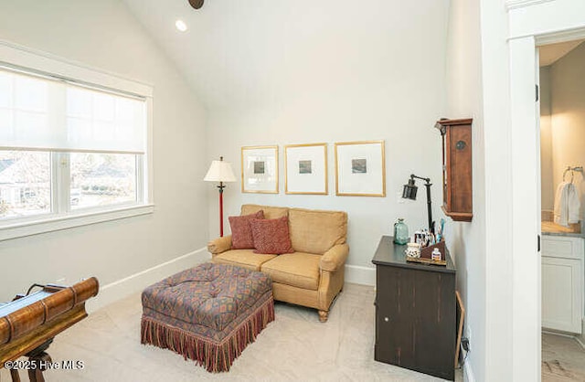 sitting room featuring lofted ceiling