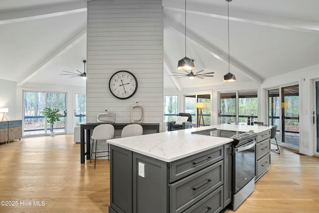 kitchen featuring pendant lighting, stainless steel electric range, light stone countertops, a kitchen island, and beamed ceiling