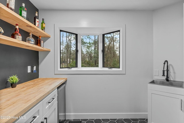 laundry room with wine cooler and wet bar