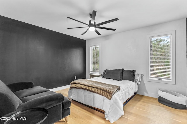 bedroom featuring light hardwood / wood-style flooring and ceiling fan