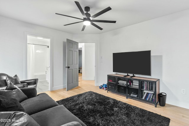 living room with light hardwood / wood-style flooring and ceiling fan