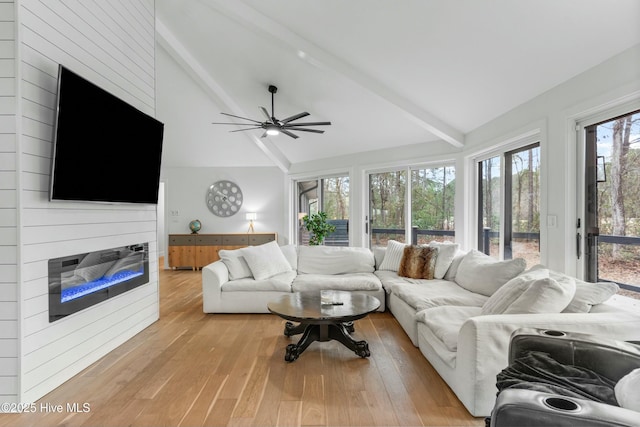 living room with high vaulted ceiling, light hardwood / wood-style floors, beamed ceiling, and ceiling fan