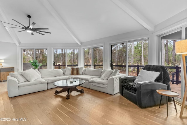 sunroom with lofted ceiling with beams and ceiling fan