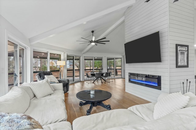 living room with beam ceiling, wood-type flooring, high vaulted ceiling, and ceiling fan