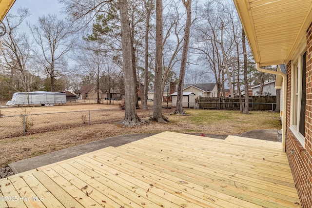 wooden deck featuring a lawn